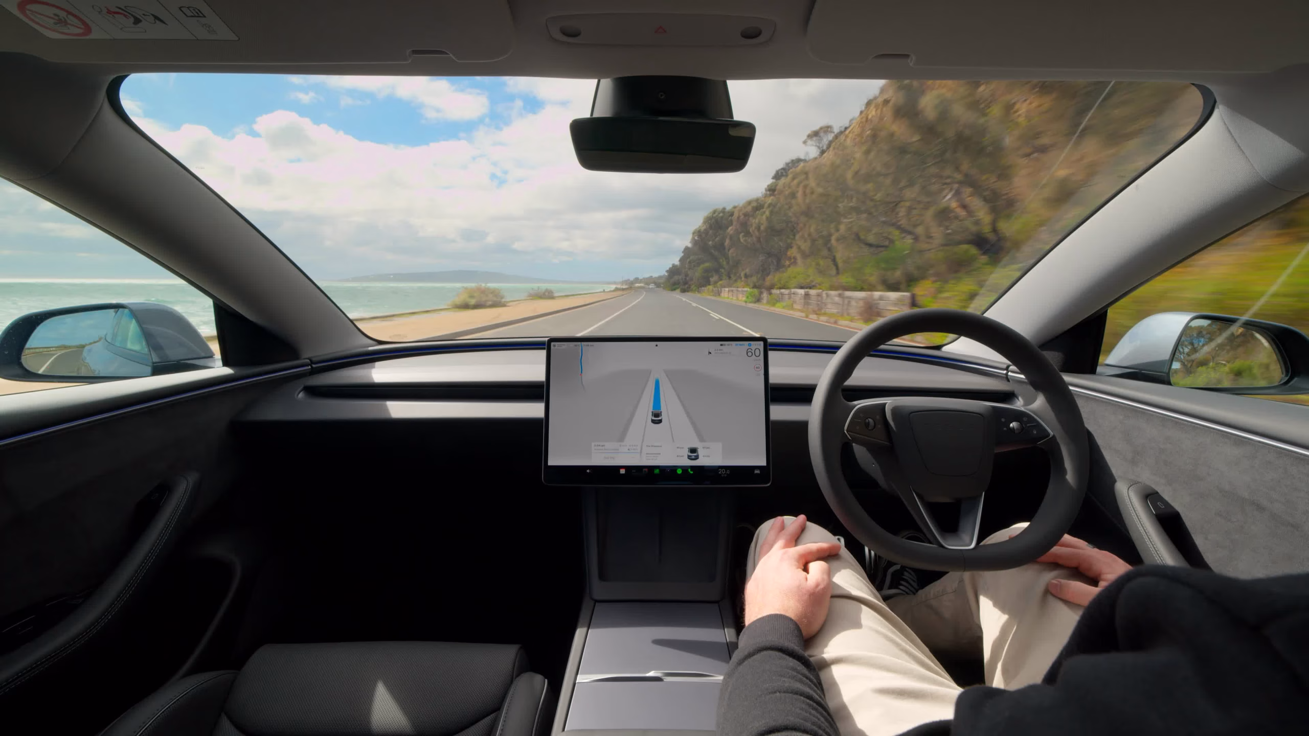 Tesla FSD approved in Denmark — driver inside Tesla with FSD Supervised system active on Danish roads.